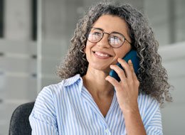woman holding coffee mug looking at cellphone